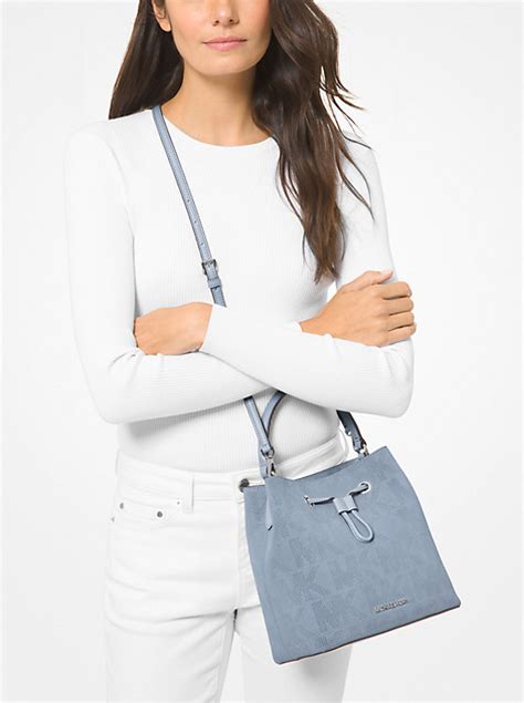 Suri Medium Logo Perforated Suede Crossbody Bag.